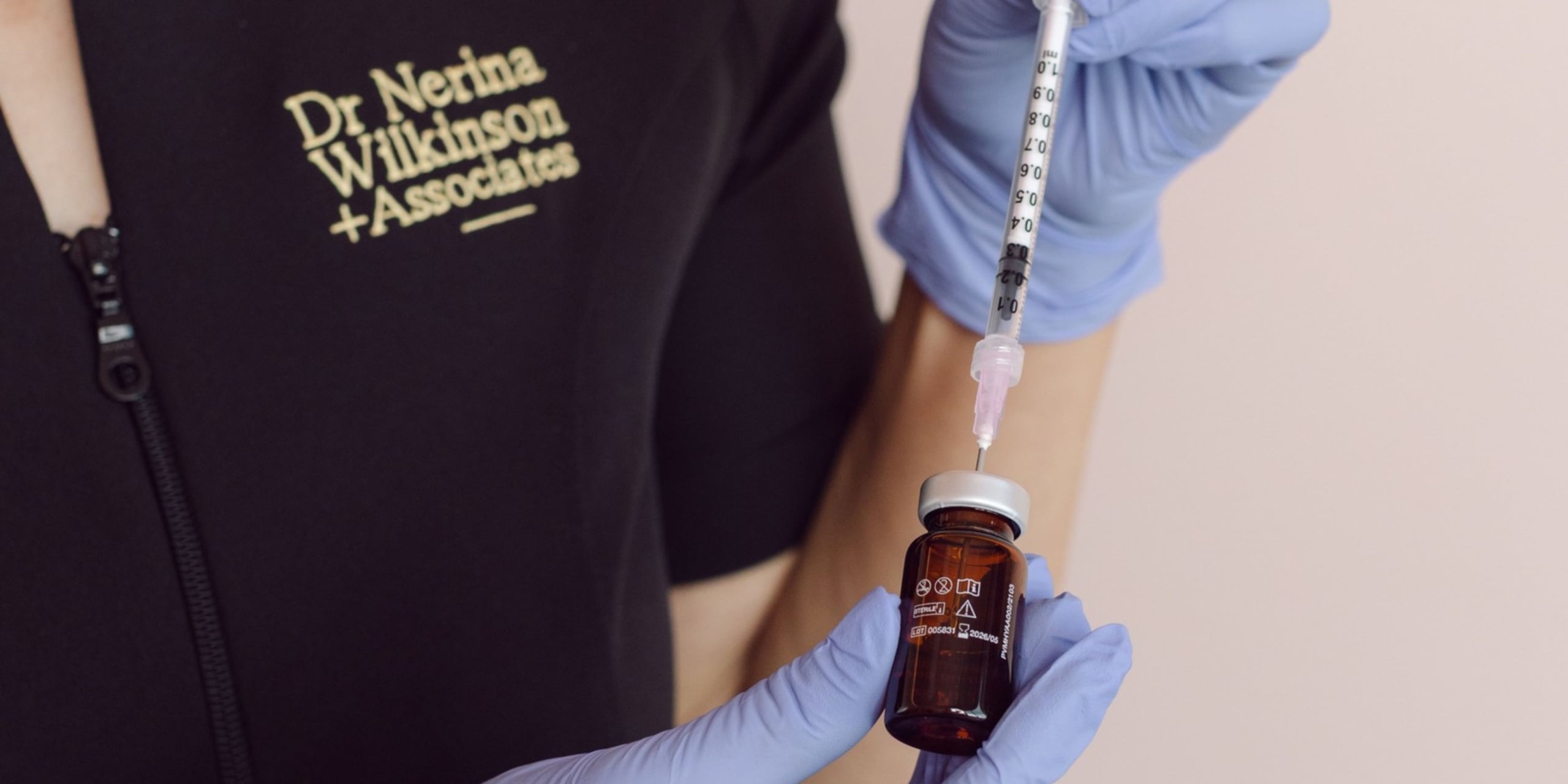 A skincare specialist preparing an active ingredient to use in a professional skincare treatment